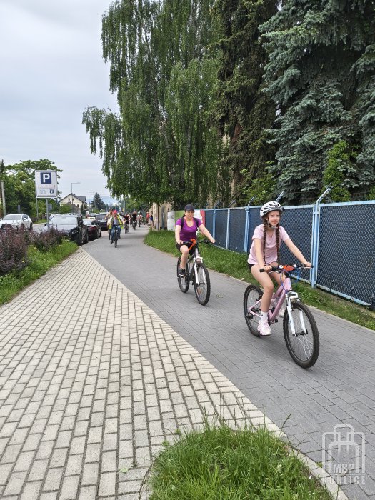 Biblioteka Gorlice, Odjazdowy Bibliotekarz dwie osoby na rowerch jada ścieżka rowerową w tle więcej rowerzystów